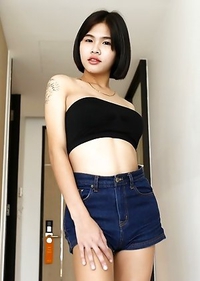 21yo busty Thai shemale Gogo strips for the camera to tease her white cock date