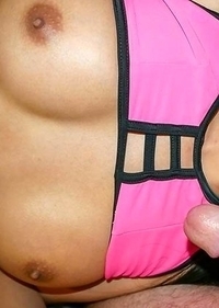 Delicious Ladyboy Yogurt is wearing a pink and black bikini with a blue baseball cap. She lifts up her top to her nice, round tits out and she squishe