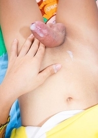 Ladyboy Lee is wearing a little yellow dress with white panties and socks.